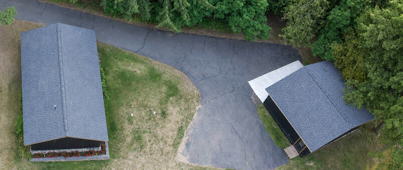 Overhead aerial view of matching shingle roofs on a Northwoods cabin and detached garage